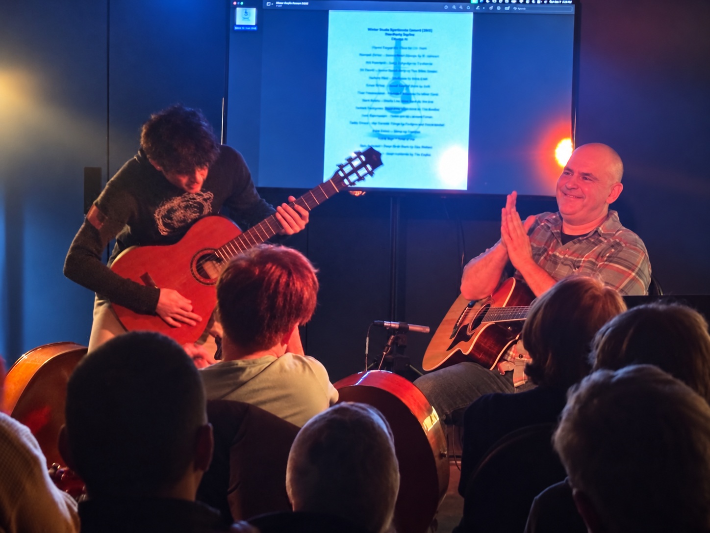 Ben McMunn applauding a student at the winter studio concert at ShooBooty Studios